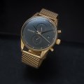 Gold dual time watch with date Spring Summer Collection MVMT